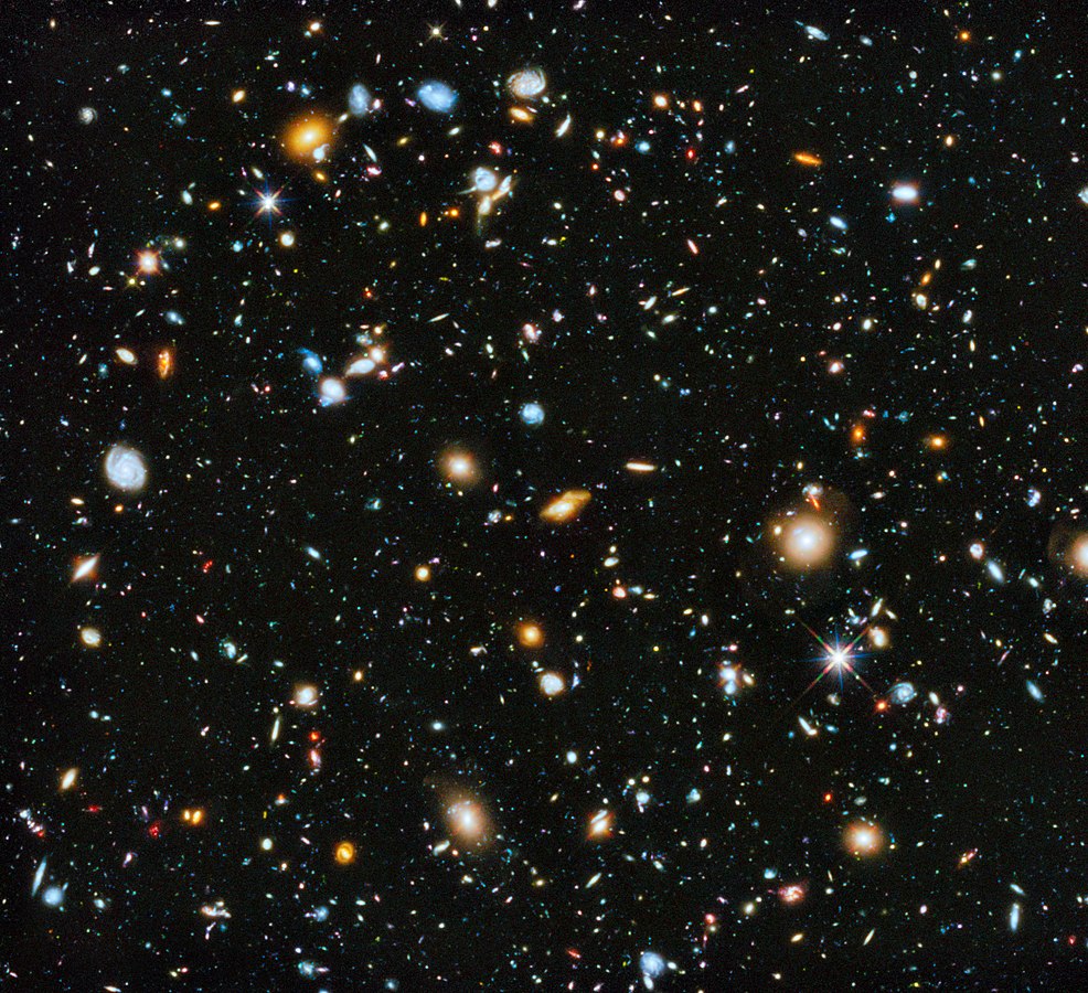 The Hubble Ultra-Deep Field image, showing many different far, far away galaxies; in most cases, it took billions of years for the light from these galaxies to reach Earth. Each galaxy shown may be composed of many billions of individual stars, each of which may have its own solar system of planets.